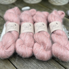 Four skeins of fluffy pink yarn