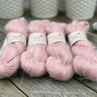 Four skeins of fluffy pink yarn