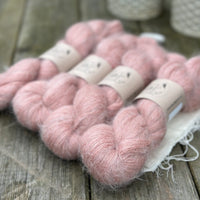 Four skeins of fluffy pink yarn