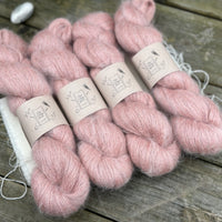 Four skeins of fluffy pink yarn