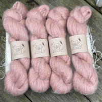 Four skeins of fluffy pink yarn