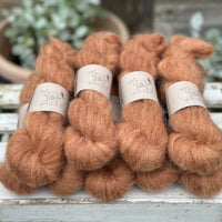 9 skeins of fluffy reddish-brown yarn