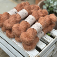 9 skeins of fluffy reddish-brown yarn