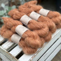 9 skeins of fluffy reddish-brown yarn