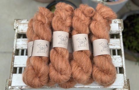 9 skeins of fluffy reddish-brown yarn 