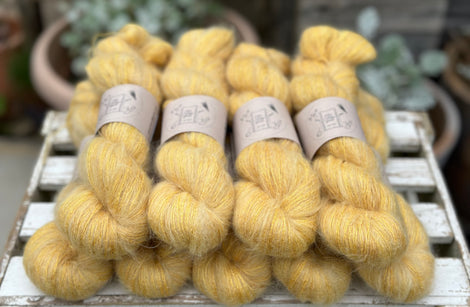 9 skeins of fluffy yellow yarn