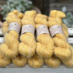 9 skeins of fluffy yellow yarn