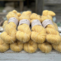 9 skeins of fluffy yellow yarn