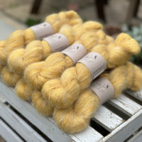 9 skeins of fluffy yellow yarn