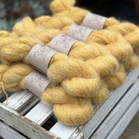 9 skeins of fluffy yellow yarn