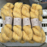 9 skeins of fluffy yellow yarn