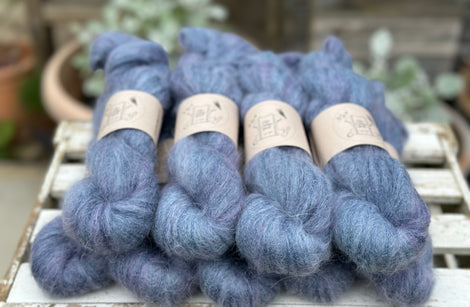 9 skeins of fluffy blue yarn