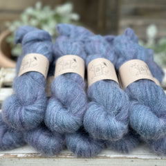 9 skeins of fluffy blue yarn