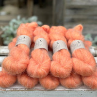 9 skeins of fluffy orange yarn