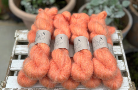 9 skeins of fluffy orange yarn