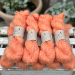 9 skeins of fluffy orange yarn