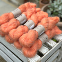 9 skeins of fluffy orange yarn