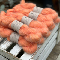 9 skeins of fluffy orange yarn