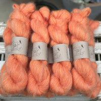 9 skeins of fluffy orange yarn