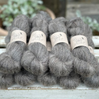 9 skeins of fluffy dark grey yarn