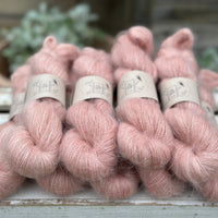 9 skeins of fluffy pink yarn