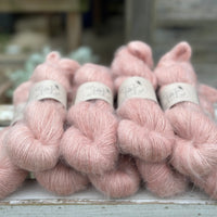 9 skeins of fluffy pink yarn