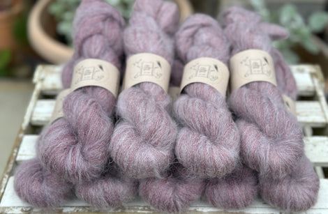 9 skeins of fluffy purple yarn