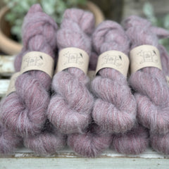 9 skeins of fluffy purple yarn