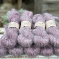 9 skeins of fluffy purple yarn