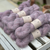 9 skeins of fluffy purple yarn