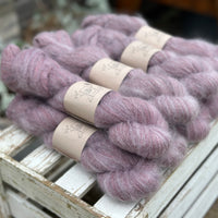 9 skeins of fluffy purple yarn