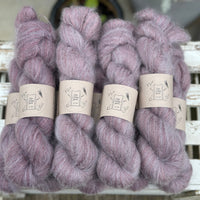 9 skeins of fluffy purple yarn