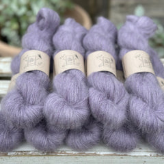 9 skeins of fluffy purple yarn