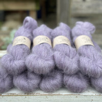 9 skeins of fluffy purple yarn