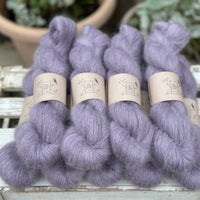 9 skeins of fluffy purple yarn