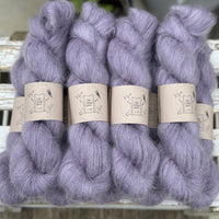 9 skeins of fluffy purple yarn