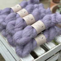 9 skeins of fluffy purple yarn