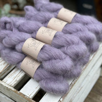 9 skeins of fluffy purple yarn