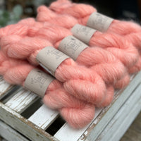 9 skeins of fluffy pink yarn