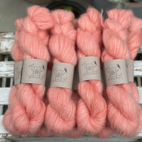 9 skeins of fluffy pink yarn