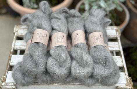 9 skeins of fluffy grey yarn