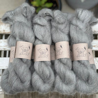 9 skeins of fluffy grey yarn