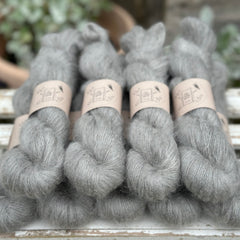 9 skeins of fluffy grey yarn