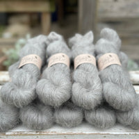 9 skeins of fluffy grey yarn