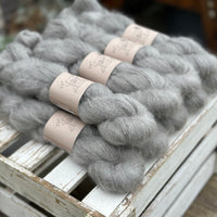 9 skeins of fluffy grey yarn