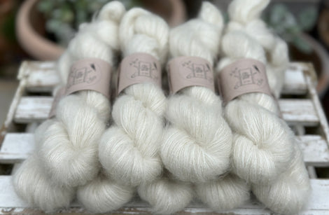 9 skeins of natural cream coloured yarn