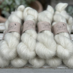 9 skeins of natural cream coloured yarn