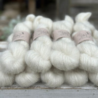 9 skeins of natural cream coloured yarn