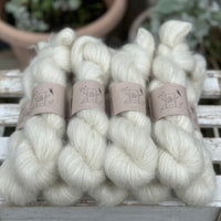 9 skeins of natural cream coloured yarn