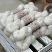 9 skeins of natural cream coloured yarn